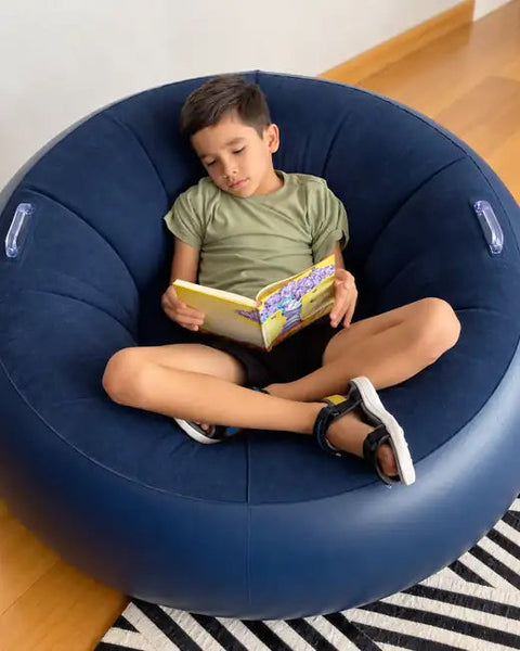 Calm: boy reading in his Calm Orbit chair